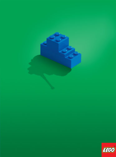 Advertising Photographers, pair of Legos casts the shadow of a tank on a green background